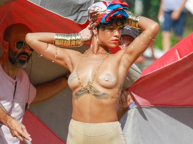 Rihanna poses topless for Vogue 